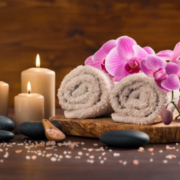 Serene spa setting at Atlas Massage Therapy in London with orchids and candles.